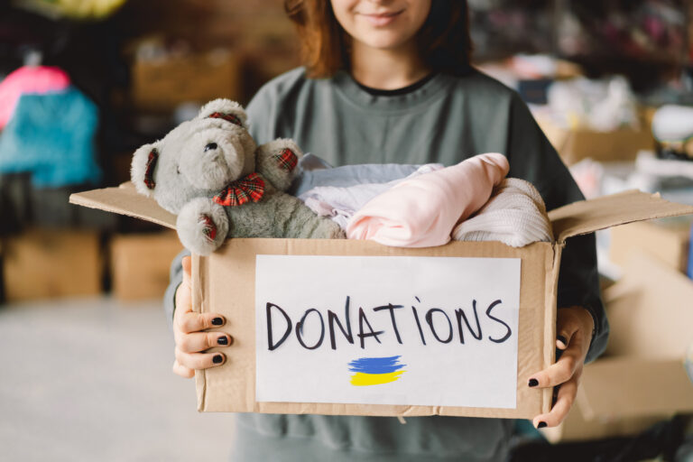 Volunteer teengirl preparing donation boxes for people in need in Ukraine